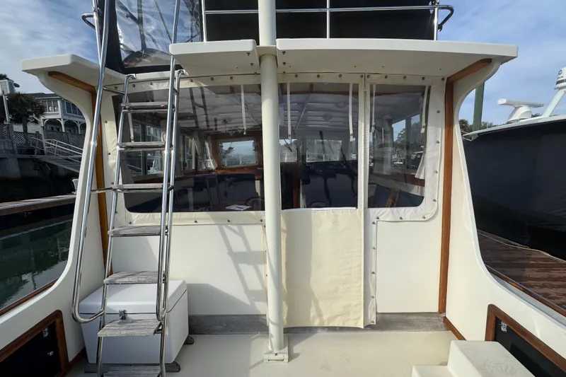 Slide: The Image of 2001 Ellis 36 Flybridge boat with ladder and enclosed deck area. - 8