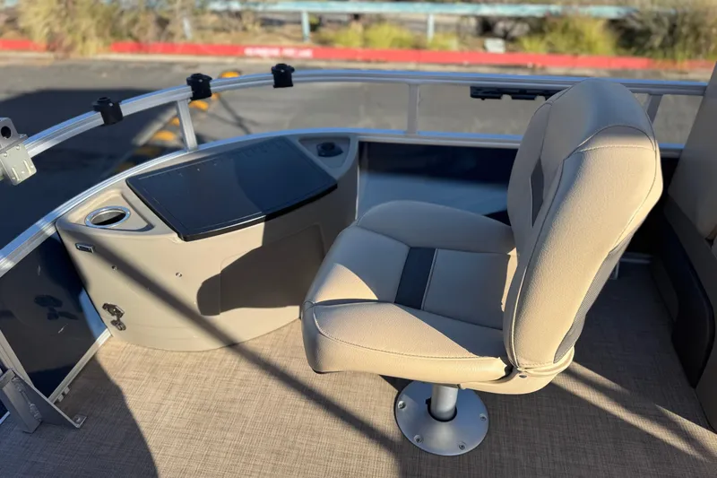 Slide: The Image of 2022 Sun Tracker Fishin' Barge 22 DLX captain's chair and console, outdoor setting. - 13