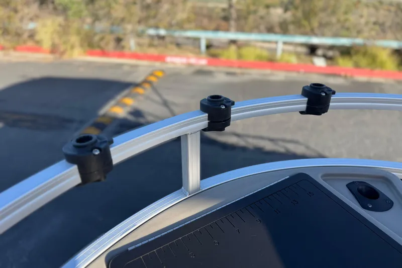 Slide: The Image of 2022 Sun Tracker Fishin' Barge 22 DLX boat railing with rod holders. - 15