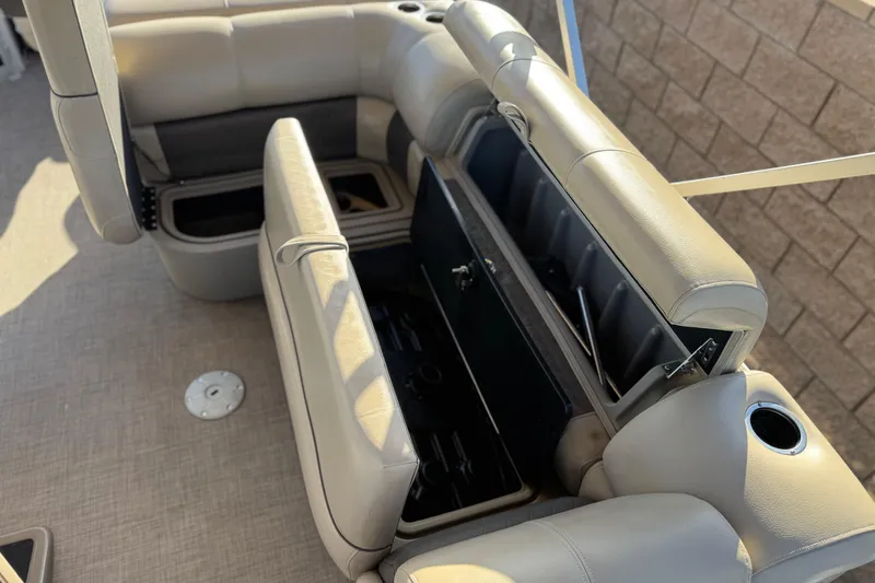 Slide: The Image of 2022 Sun Tracker Fishin' Barge 22 DLX interior with open storage compartments. - 21