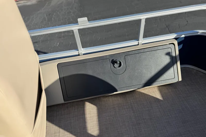 Slide: The Image of 2022 Sun Tracker Fishin' Barge 22 DLX deck with storage compartment and railing. - 22