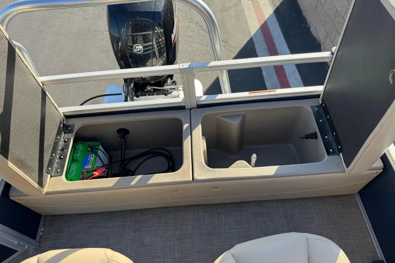 Slide: The Image of 2022 Sun Tracker Fishin' Barge 22 DLX storage compartments with battery and motor view. - 25