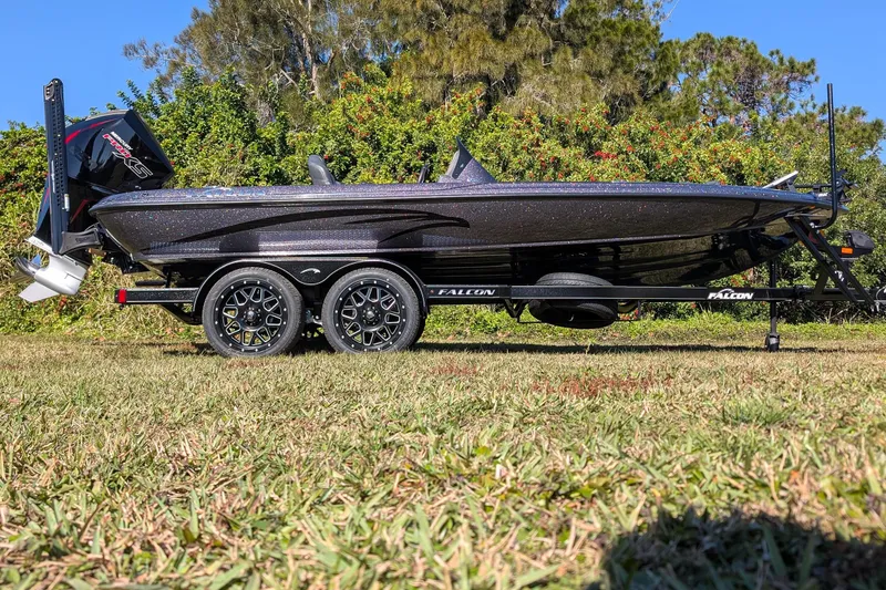 Slide: The Image of 2026 Falcon F20 PREDATOR boat on trailer, parked on grass with trees in background. - 5