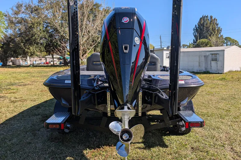 Slide: The Image of 2026 Falcon F20 PREDATOR boat, rear view with powerful outboard motor, parked on grass. - 10
