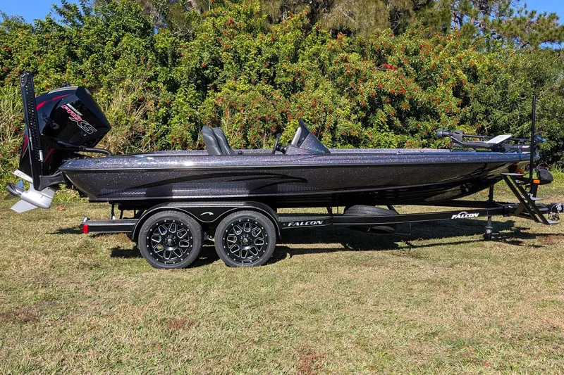 Slide: The Image of 2026 Falcon F20 PREDATOR boat on trailer, parked on grass with lush greenery background. - 4