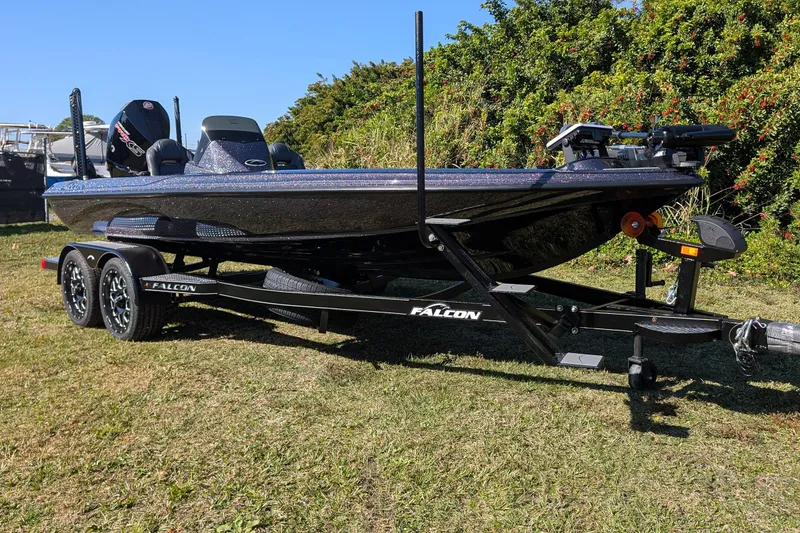 Slide: The Image of 2026 Falcon F20 PREDATOR boat on trailer, parked on grass, surrounded by greenery. - 7