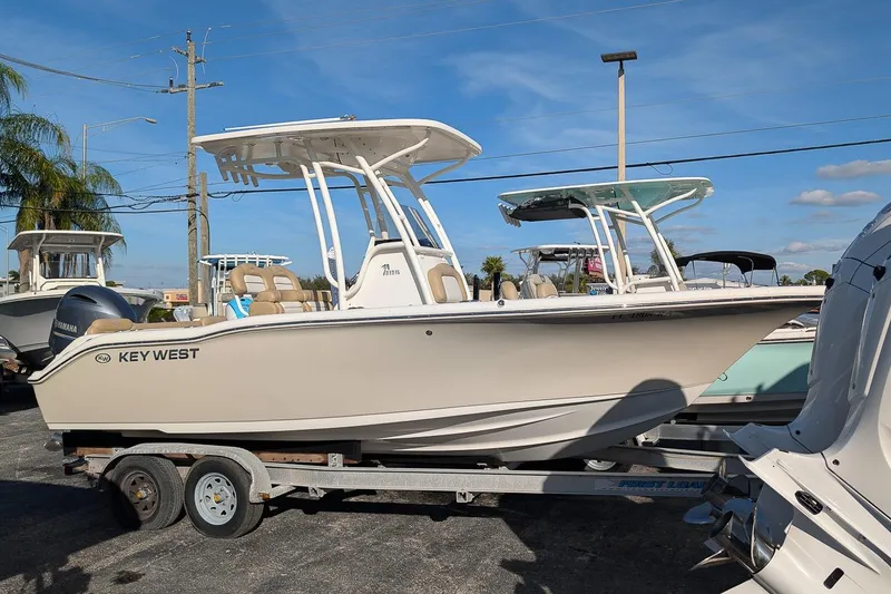 The Image of 2016 Key West 219 FS boat on trailer under clear blue sky. - 0