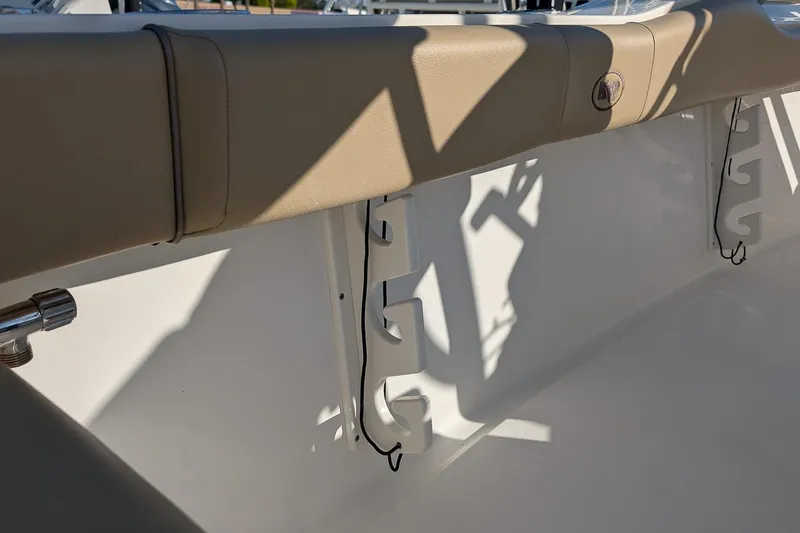 Slide: The Image of Interior view of 2016 Key West 219 FS boat, featuring beige upholstery and white paneling. - 10