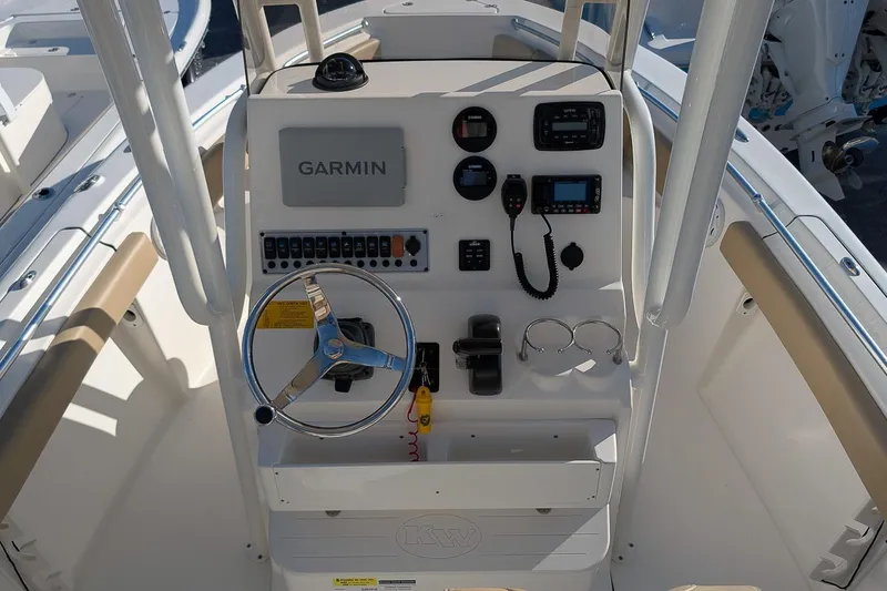 Slide: The Image of 2016 Key West 219 FS boat console with Garmin navigation and steering wheel. - 13