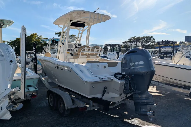Slide: The Image of 2016 Key West 219 FS boat with Yamaha engine on trailer in marina. - 2