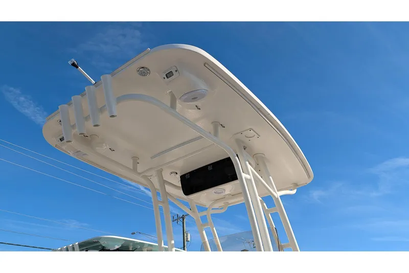 Slide: The Image of 2016 Key West 219 FS boat T-top against clear blue sky. - 21