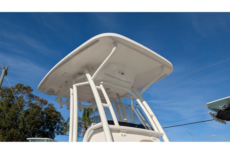 Slide: The Image of 2016 Key West 219 FS boat T-top against clear blue sky. - 22