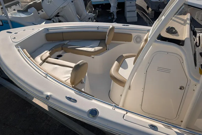 Slide: The Image of 2016 Key West 219 FS boat interior with cushioned seating and console. - 6