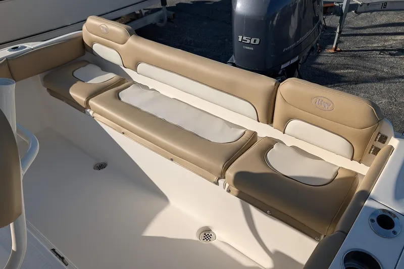 Slide: The Image of 2016 Key West 219 FS boat interior with beige seating and Yamaha 150 engine. - 7