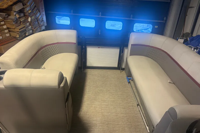 Slide: The Image of Interior of 2023 Qwest Lanai 820 pontoon boat with beige seating and storage boxes. - 7
