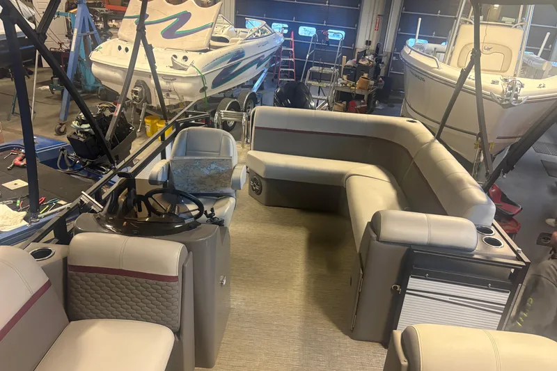 Slide: The Image of 2023 Qwest Lanai 820 pontoon boat interior in a workshop setting. - 9
