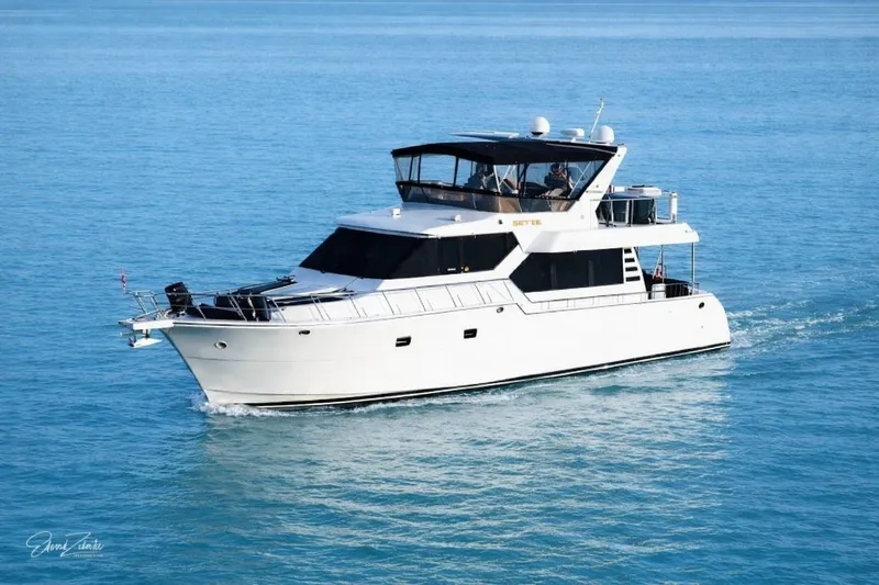 The Image of 2003 Altima 55 Pilothouse yacht cruising on clear blue water. - 0