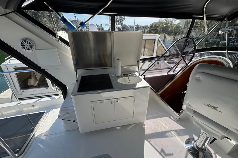 Slide: The Image of 2003 Altima 55 Pilothouse yacht interior with kitchenette and seating area. - 11