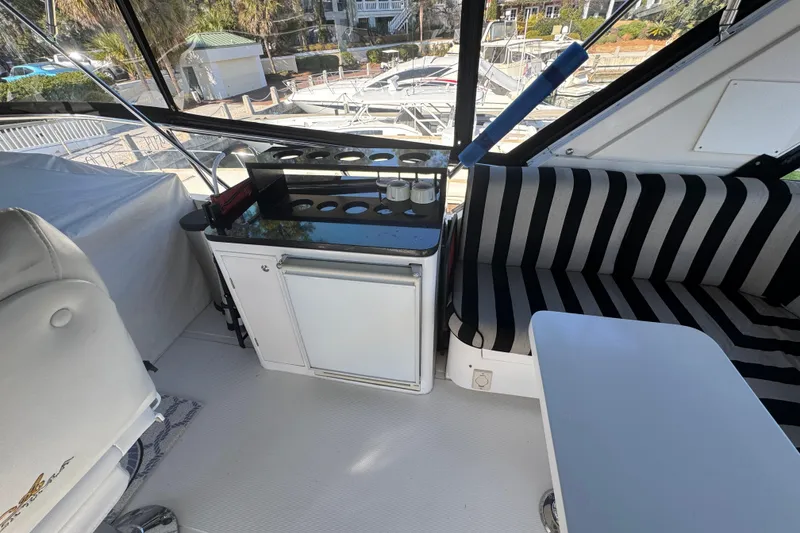 Slide: The Image of Interior of 2003 Altima 55 Pilothouse with striped seating and kitchenette. - 12