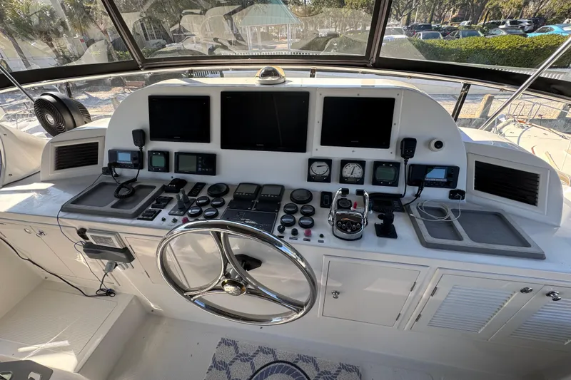 Slide: The Image of Pilothouse of 2003 Altima 55, featuring navigation screens, controls, and steering wheel. - 15