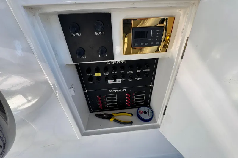 Slide: The Image of Electrical panel of 2003 Altima 55 Pilothouse boat with tools and wiring components. - 16