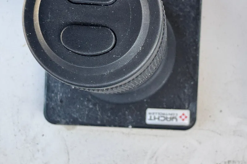 Slide: The Image of 2003 Altima 55 Pilothouse interior with striped seating and marina view. - 17