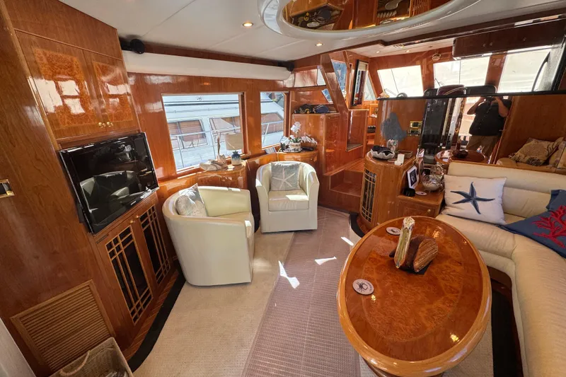 Slide: The Image of Luxurious interior of 2003 Altima 55 Pilothouse yacht with elegant seating and wooden accents. - 24