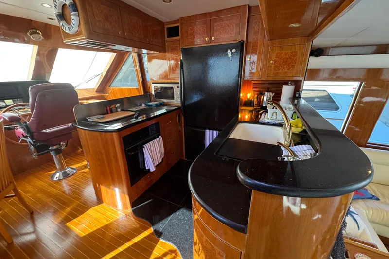 Slide: The Image of Luxurious 2003 Altima 55 Pilothouse interior with wood flooring and elegant decor. - 29