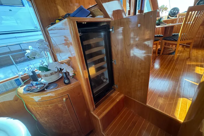 Slide: The Image of Luxurious 2003 Altima 55 Pilothouse interior with elegant dining setup and navigation controls. - 31