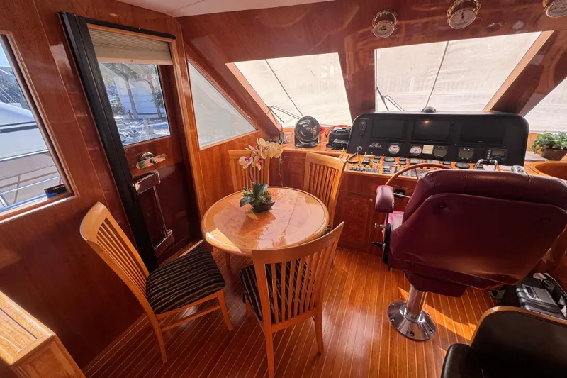 Slide: The Image of Luxurious interior of 2003 Altima 55 Pilothouse yacht with wooden finishes and elegant seating. - 32
