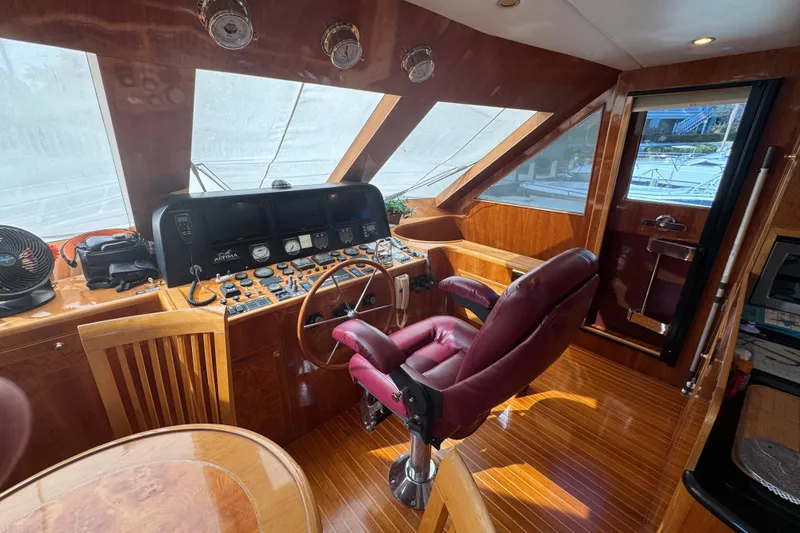 Slide: The Image of Luxurious bedroom in 2003 Altima 55 Pilothouse yacht with blue bedding and red throw. - 33