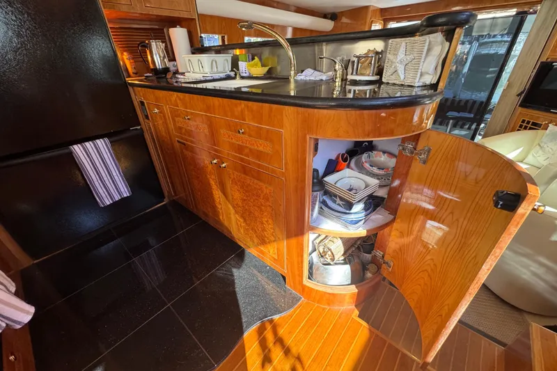 Slide: The Image of Luxurious 2003 Altima 55 Pilothouse cabin with elegant wood paneling and cozy bedding. - 34
