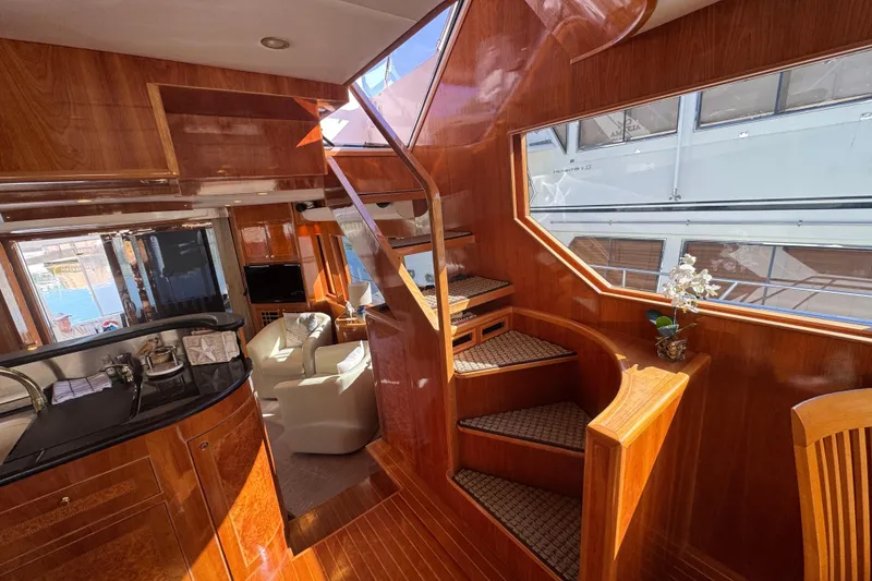 Slide: The Image of Luxurious 2003 Altima 55 Pilothouse cabin with elegant wood paneling and cozy bedding. - 35
