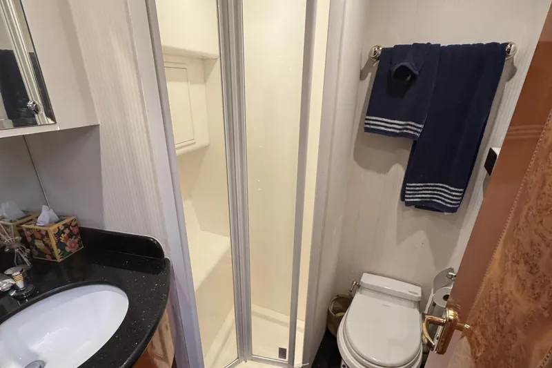 Slide: The Image of Luxurious bedroom interior of 2003 Altima 55 Pilothouse yacht with elegant wood finish. - 40