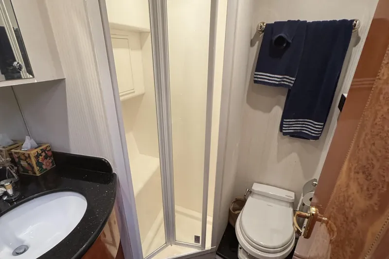 Slide: The Image of Luxurious bedroom interior of 2003 Altima 55 Pilothouse yacht with wood accents and modern amenities. - 41