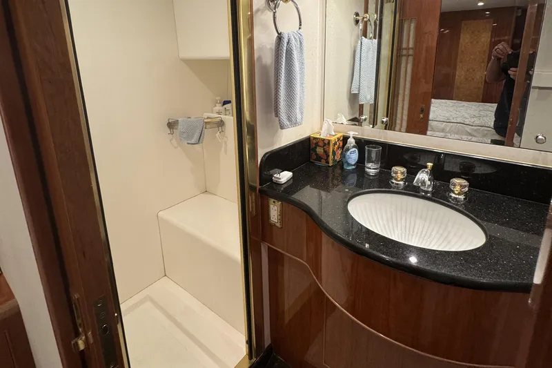 Slide: The Image of Interior of 2003 Altima 55 Pilothouse with TV and open cabinet revealing safe. - 45