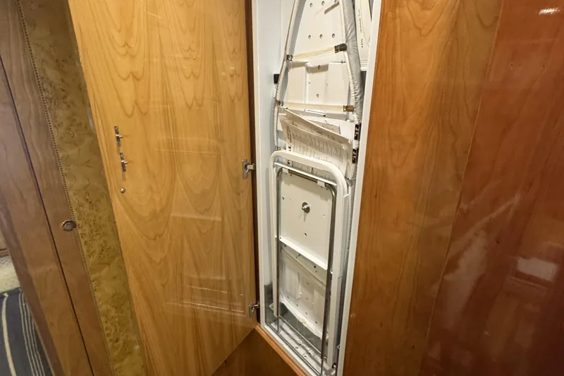 Slide: The Image of Wooden staircase inside 2003 Altima 55 Pilothouse yacht with sunset view. - 52