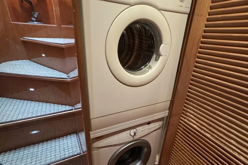 Slide: The Image of Engine room of 2003 Altima 55 Pilothouse yacht, featuring dual engines and mechanical components. - 54