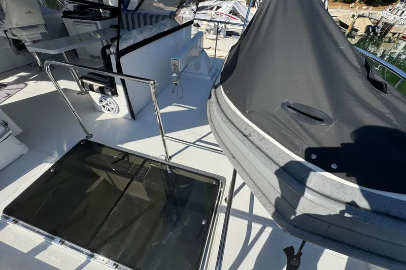 Slide: The Image of 2003 Altima 55 Pilothouse yacht deck with seating and covered equipment. - 9