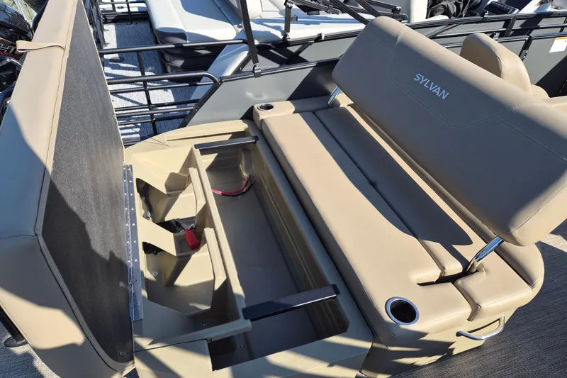 Slide: The Image of 2026 Sylvan MIRAGE 822 CLZ DH boat interior with tan seating and storage compartments. - 13