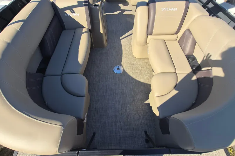 Slide: The Image of 2026 Sylvan MIRAGE 822 CLZ DH boat interior with beige seating and carpeted floor. - 5