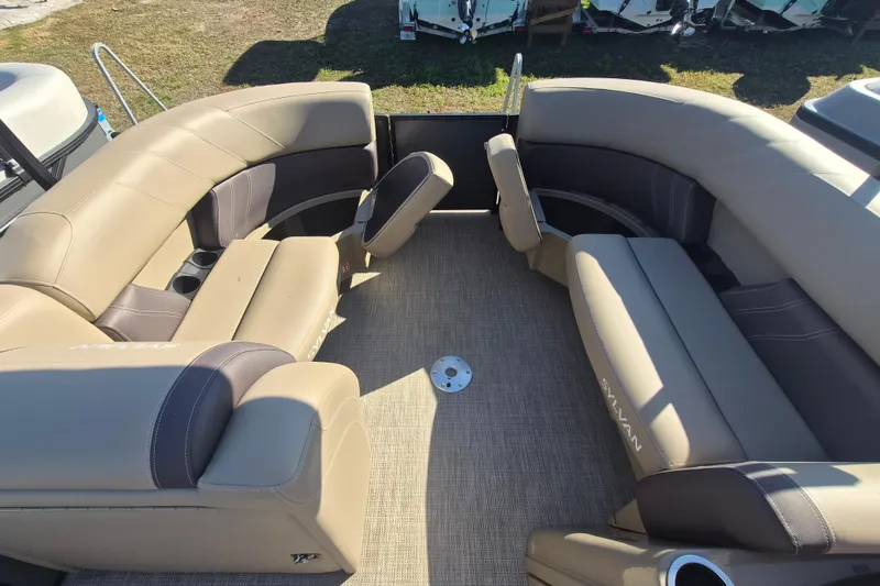 Slide: The Image of 2026 Sylvan MIRAGE 822 CLZ DH pontoon boat interior with beige seating and cup holders. - 6