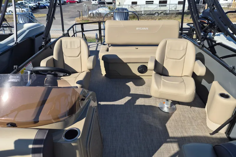 Slide: The Image of 2026 Sylvan MIRAGE 822 CLZ DH boat interior with beige seating and steering console. - 7