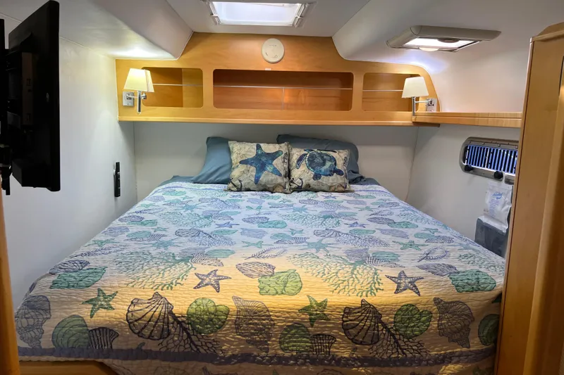 Slide: The Image of Cozy bedroom in 2011 Privilege 495 yacht with nautical-themed bedding and ambient lighting. - 101