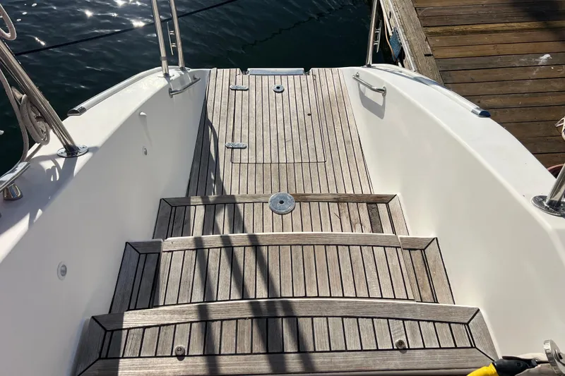 Slide: The Image of Stern view of 2011 Privilege 495 yacht with wooden deck and dockside mooring. - 106