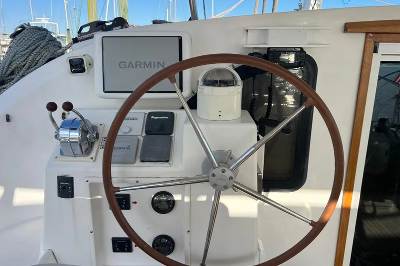 Slide: The Image of Helm of 2011 Privilege 495 yacht with Garmin navigation system and steering wheel. - 11