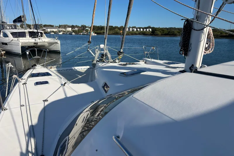 Slide: The Image of Catamaran Privilege 495, 2011 model, docked in a serene marina setting. - 19