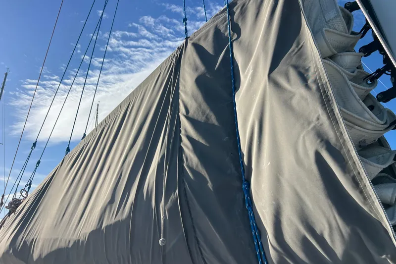Slide: The Image of Sail of a 2011 Privilege 495 yacht against a clear blue sky. - 26