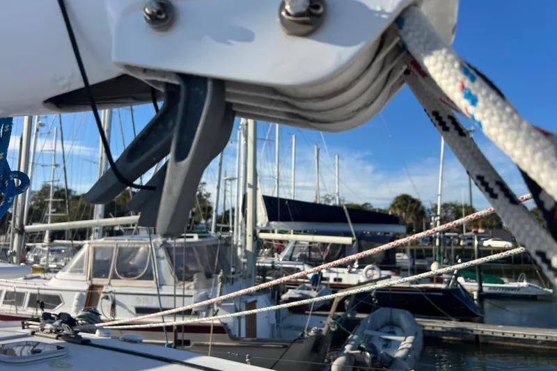 Slide: The Image of Sailboat rigging on a 2011 Privilege 495 at a marina, with clear blue skies. - 27