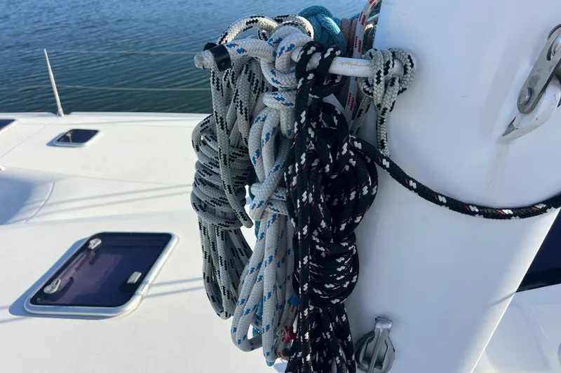 Slide: The Image of Ropes on a 2011 Privilege 495 sailboat deck, near mast, with water background. - 29
